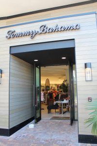 Brick walkway leading to storefront entrance, wood paneling building exterior, inset double outward swinging K2-Summit Impact Door by Aldora that lead to store interior