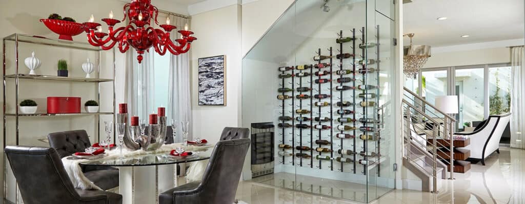Looking at a wine room enclosed in SMI-45 Aldora glass. Beyond the room are stairs, furniture and a patio door