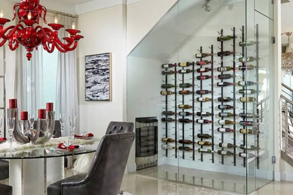 Looking at a wine room enclosed in SMI-45 Aldora glass. Beyond the room are stairs, furniture and a patio door