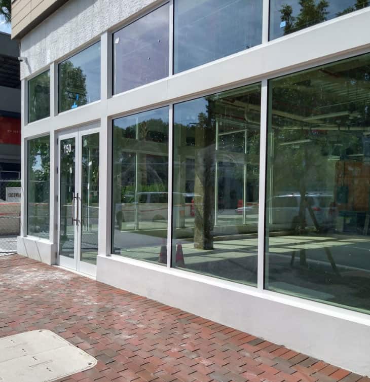 Glass entrance and storefront by Aldora.