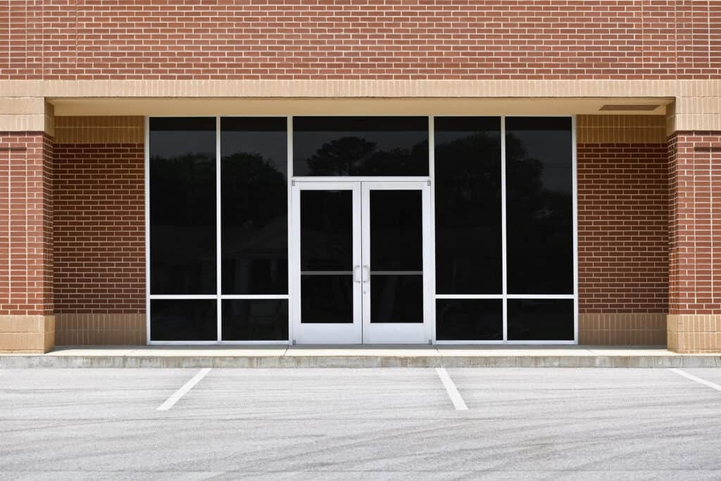Full view of Level E Impact door on brick office building.