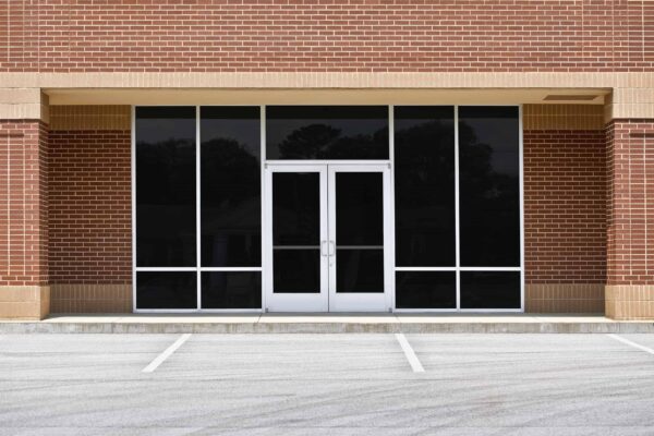 Full view of Level E Impact door on brick office building.