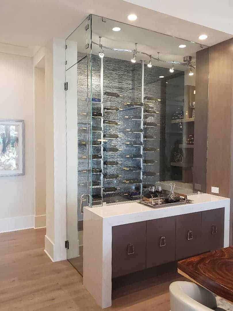 Custom glass wine room with a bar stationed in front.