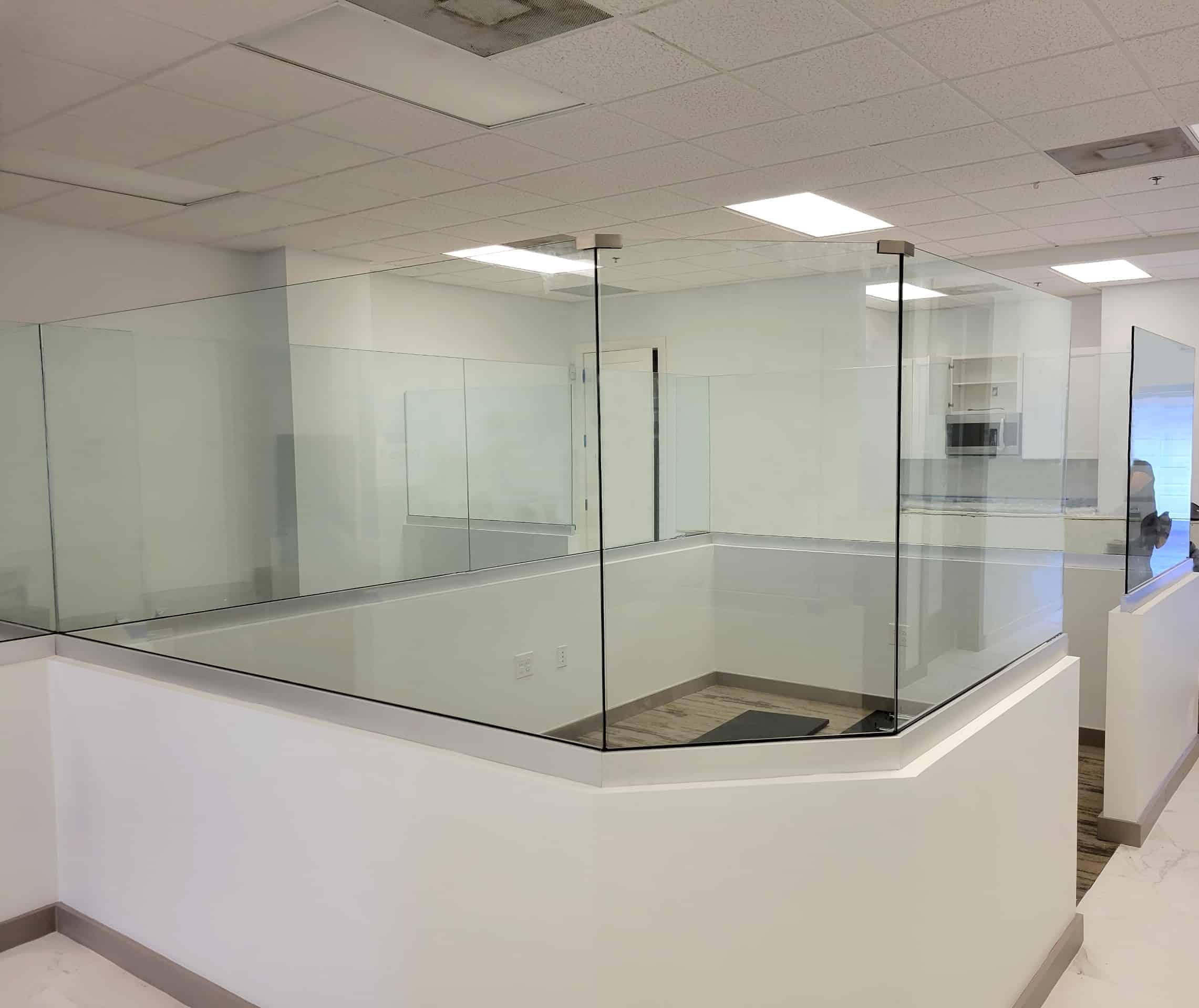 Half wall, glass partitions around several office cubicles