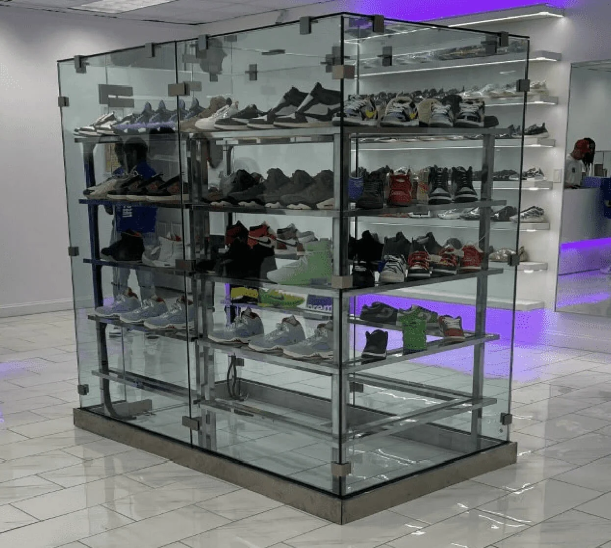 Custom glass case with multiple shoes inside.