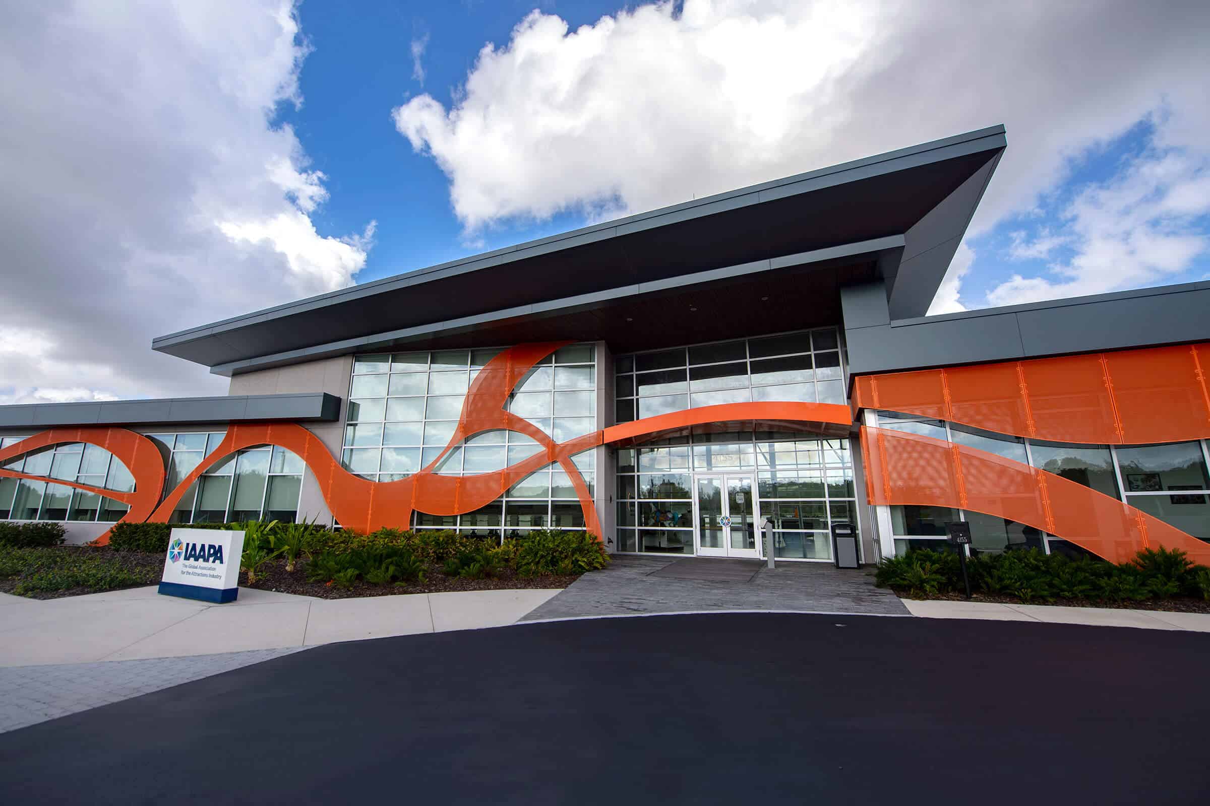 Commercial storefront building with SN68 glass and wavy orange design elements