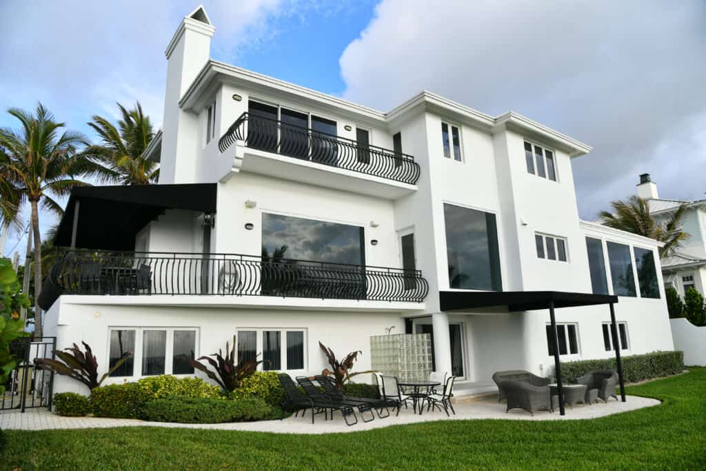white luxury home with custom windows and doors