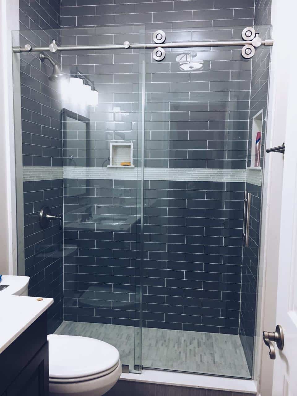 glass shower with blue tile