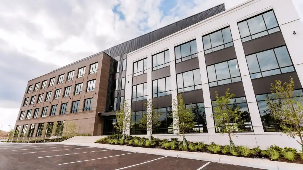 exterior of three-storey building with large glass windows